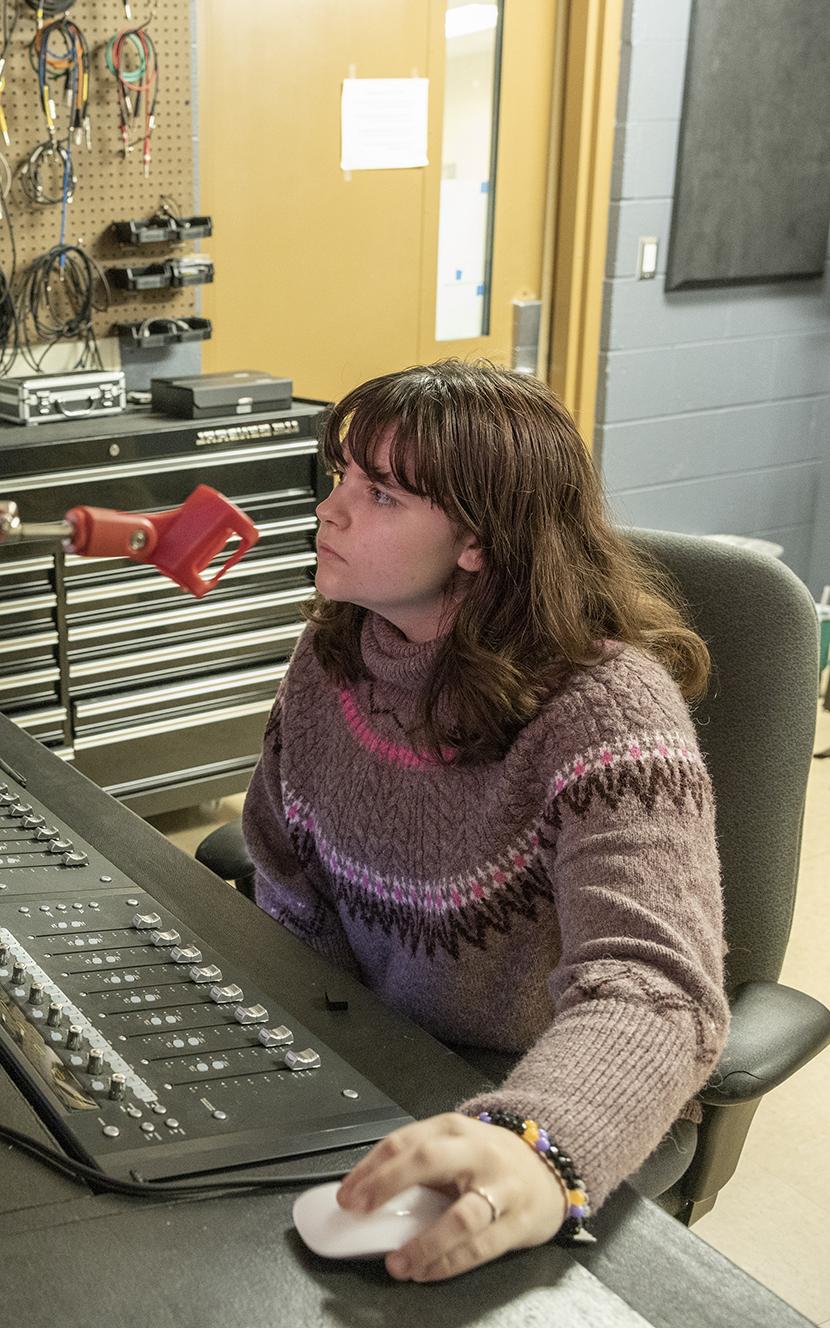 Stevie Lyles at a mixing board in the Department of Music